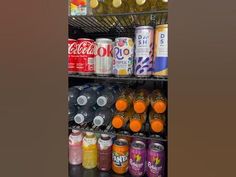 an assortment of sodas and soft drinks on shelves