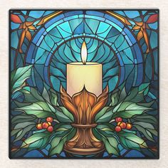 a stained glass window with a candle in the center and leaves surrounding it on a coaster