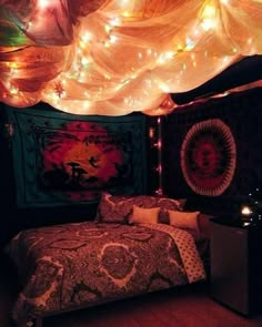 a bed room with a neatly made bed and some lights on the wall above it