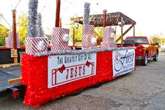 a truck is decorated with red and silver decorations for the holiday season, along with other festive items