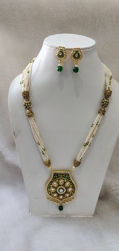 Gold plated Kundan long necklace with matching delicate earrings Highest quality and craftsmanship Indian Bridal Traditional Jewelry Necklace Set. All the raw material used in this product is of high quality and is handcrafted with love. Premium Quality and High craftsmanship 100% Satisfaction Guarantee: Long Lasting Plating, High-Quality Stones. Gifting: This pair of charming necklace and earrings come in a beautiful gift box, making it an ideal gift for birthday, wedding anniversary or wedding gift. Occasion: Perfect choice for any Occasion. Care: It is advisable that you keep our products away from direct heat, humidity, and moisture. Contact us for any question. Formal White Jewelry Sets With Meenakari, Formal White Meenakari Jewelry Sets, Ornate White Jewelry For Festive Season, Elegant White Necklace With Latkans, Elegant White Temple Necklace With Latkans, Ornate White Jewelry For Festive Occasions, Ornate White Jewelry For Celebrations, Handmade Gold Long Necklace For Wedding, Ornate White Jewelry For Festivals