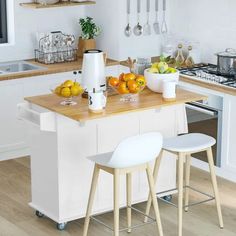 a kitchen island with two stools in front of it next to a stove top oven