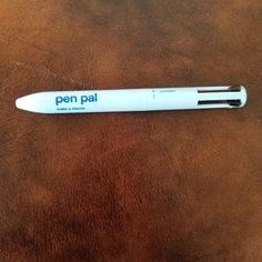 a pen sitting on top of a brown horse's leather seat with the word pen pal written on it