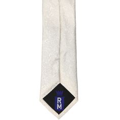 This elegant and timeless ivory slim tie is perfect for your wedding day. The tone-on-tone floral pattern is easy to match and can be worn with just about anything, from fitted groomsmen suits to a simplified tie and suspenders combo. For those in your wedding party who prefer a more traditional tie, this pattern comes in wider widths and bow ties. This is a slim tie, measuring 2.5-inches wide, which is a modern tie size without being too skinny. The pattern has a textured feel and is made from White Fitted Tie For Black Tie Events, Fitted White Ties For Black Tie Occasions, Classic White Tie For Wedding, Dapper White Tie For Black Tie Events, Dapper White Ties For Black Tie Events, White Dapper Ties For Black Tie Events, Dapper White Suit And Standard Tie Accessories, Dapper White Adjustable Suit And Tie Accessories, Classic White Wedding Tie