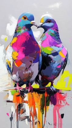 two birds sitting on top of each other with colorful paint splatters all over them