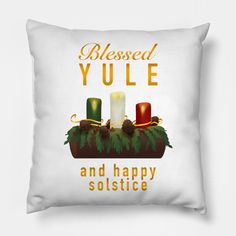 a white pillow with candles on it that says, blessed yule and happy solstice