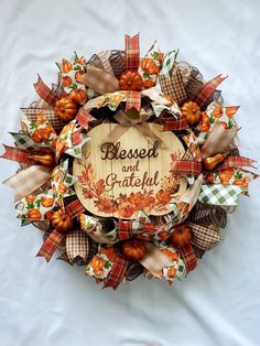 a wreath that has been made to look like it is decorated with fall leaves and pumpkins