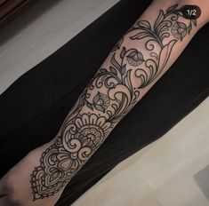 a person with a black and white tattoo on their arm