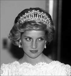 a woman wearing a tiara and earrings