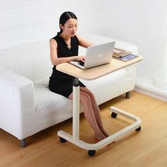 a woman sitting at a desk using a laptop computer