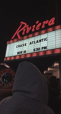 a sign that says riviera chase atlantic in front of a building at night