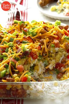 a casserole dish is loaded with vegetables and cheese on the top, ready to be eaten