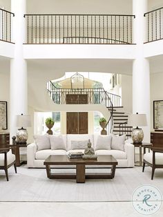 a living room filled with furniture and a spiral staircase