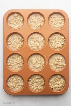 a muffin tray filled with lots of oatmeal