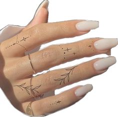 a woman's hand with four finger tattoos on it