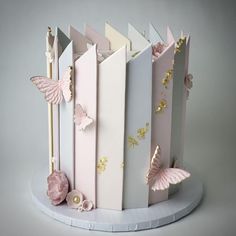 a cake made to look like an open book with butterflies on the front and sides