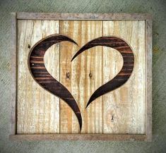 a wooden sign with two hearts carved into it