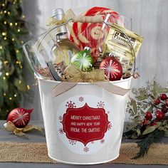 a white bucket filled with christmas items on top of a table