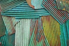 an old rusty corrugated roof with many different colors