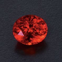 an orange diamond on a black surface