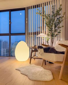 a cat laying on a chair in front of a window