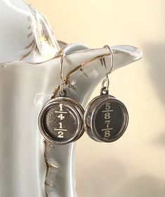 What a great gift for a math teacher or a writer! These earrings of original typewriter keys from the early 1900's, are just fun, funky jewelry to wear. This set of keys are the fractions 1/4 1/2, and 5/8 7/8. I work with antique and vintage parts. Some may show signs of wear or age. Please look at each picture closely. I have tried to show all aspects of my work. Please contact me before purchasing if you have any questions or would like more clarity in a picture. I like to think that older ite Typewriter Key Jewelry, Key Earrings, Jewelry Recycled, Typewriter Keys, Key Jewelry, Assemblage Jewelry, Falmouth, Steampunk Jewelry, Antique Buttons