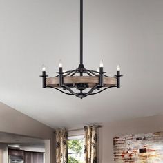 a large chandelier hanging from the ceiling in a living room with wood accents