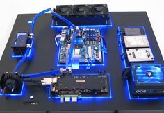 an electronic device with blue lights on it's side and some wires attached to the board