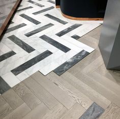 the floor is covered in black and white marble herringbone tiles, which are laid diagonally on top of each other