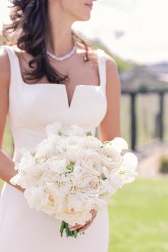 a woman in a white dress holding a bouquet