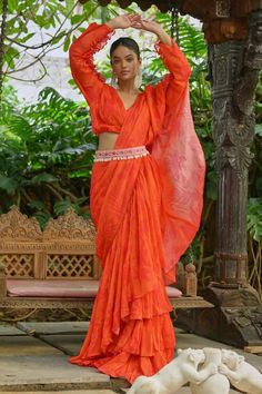 Orange layered draped saree with floral print. Paired with blouse and pearl embroidered belt. - Aza Fashions Designer Wear Pre-draped Saree With Self Design For Navratri, Navratri Pre-draped Saree With Cutdana, Chanderi Pre-draped Saree With Pallu, Fitted Pre-draped Saree With Zari Weaving For Reception, Georgette Saree With Cutdana Detailing, Georgette Saree With Cutdana, Draped Style, Reception Cotton Silk Saree With Self Design, Cotton Silk Saree With Self Design For Reception, Cutdana Draped Georgette Saree