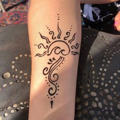 a woman's arm with a tattoo design on it