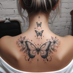 the back of a woman's neck with butterflies and stars on her upper part