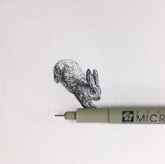 an ink pen with a drawing of a rabbit on it