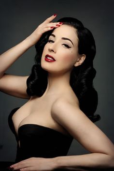 a woman with long black hair and red lipstick