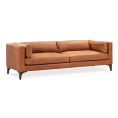 a brown leather couch sitting on top of a white floor