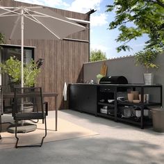 an outdoor dining area with table, chairs and umbrella