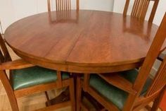 a wooden table with four chairs around it