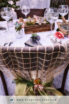 the table is set with wine glasses and napkins