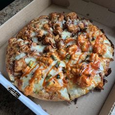 a pizza sitting inside of a box on top of a counter