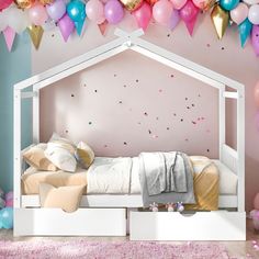 a bedroom with balloons and bed in the corner, pink walls and white furniture on carpeted floor