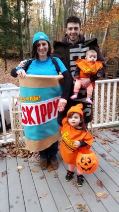 two adults and one child are dressed up as jack - o'- lantern characters