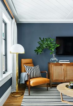 a living room with blue walls and wooden furniture