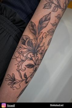 If you’re feeling extra bold, here’s a full sleeve of honeysuckle flowers! The artist combined the fascinating dotwork with the black and gray technique in order to create a floral masterpiece. This design is a powerful representation of the complexities of love, but also a reminder that every challenge has a hidden beauty, bringing with it wisdom and resilience that will make your bond all the greater. Honey Suckle Tattoo Sleeve, Honeysuckle And Thistle Tattoo, Honeysuckle Wrap Around Tattoo, Tattoo Inspo Sleeve, Honeysuckle Tattoo Black And White, Honeysuckle Arm Tattoo, Traditional Honeysuckle Tattoo, Honey Suckle Tattoo Flower, Honeysuckle Flower Drawing