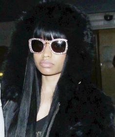 a woman wearing sunglasses and a fur coat