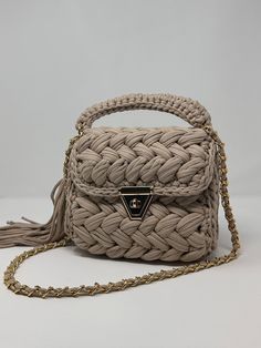 This Beige Braided Crochet Purse is the perfect way to add a pop of color to your outfit. With vibrant hues and playful patterns, this bag is sure to turn heads wherever you go. Made with high-quality yarns, this purse is not only stylish but also durable and long-lasting. Whether you're headed to the beach, the farmers' market, or a night out with friends, this is the ideal accessory for carrying your essentials in style. Weight: 2lbs  Length: 8.5 Width: 4in Height:8in  Whole Strap Lenght: 36in  All bags are shipped from US states. Fast shipping, good quality customer service Braided Crochet, Knitted Bag, Crochet Purse, Handbag Patterns, Luxury Bag, Bag Luxury, Handmade Bag, Bag Crochet, Crochet Purses