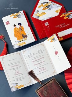 two red envelopes with chinese characters on them next to an open book and umbrella