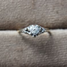 a diamond ring sitting on top of a cushion