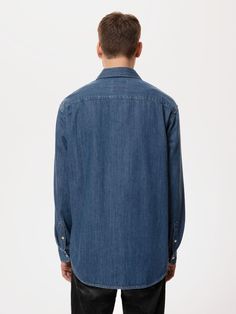 Relaxed fit denim shirt with one chest pocket made in organic cotton. This shirt is made from a perfectly comfortable 7.75 oz. denim with a flat surface. It has been washed to a mid-blue hue with subtly highlighting wash effects at the seams. Fitted Denim Shirt, Kind Of Blue, Blue Denim Shirt, Nudie Jeans, Denim Branding, Blue Hues, Denim Fabric, Denim Shirt, Chest Pocket