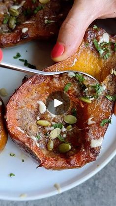 a person is cutting up some food on a plate with a knife and fork in it